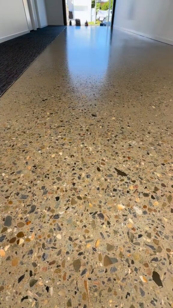 Honed and sealed exposed aggregate concrete floor in a garage, We Paint Gold Coast