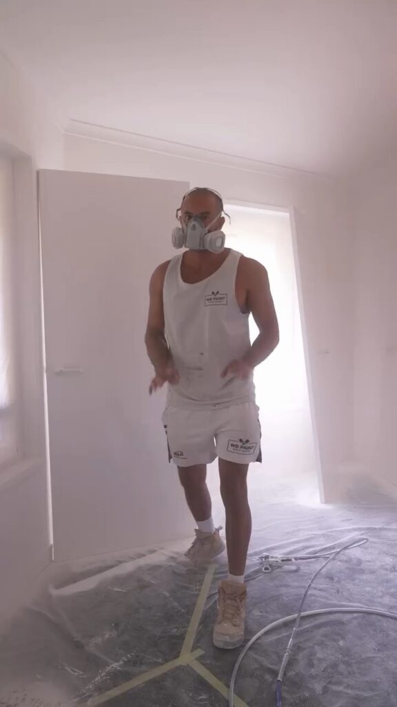 We Paint Gold Coast painter spraying an apartment interior at Princess Palm, Palm Beach